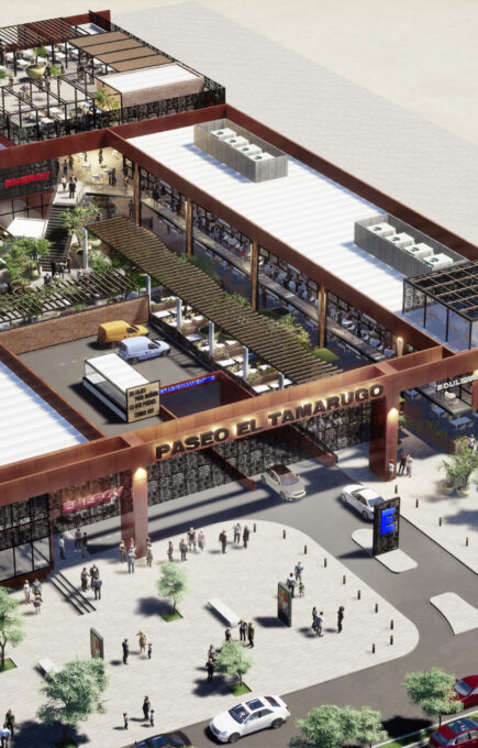 Vista aérea del centro comercial Paseo El Tamarugo, mostrando su arquitectura moderna, áreas verdes, tiendas, zonas de estacionamiento y movimiento de personas en el entorno urbano